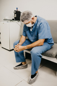 A surgeon is sitting on a chair